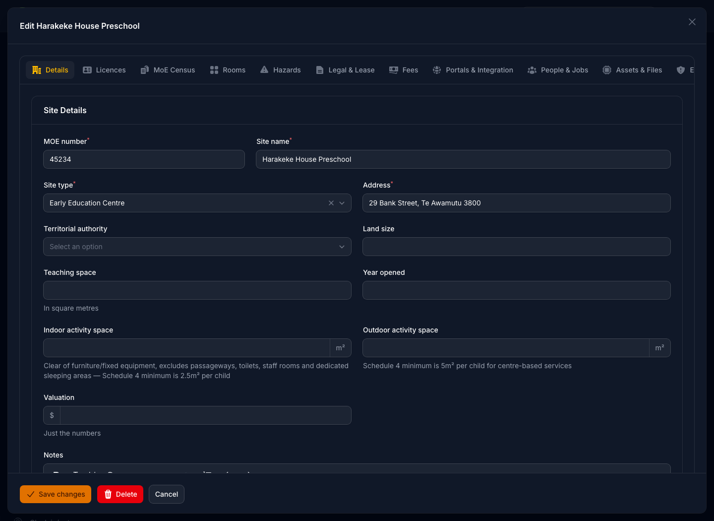 A site record open for editing in dark mode, showing its MoE number, address and service type alongside the licence conditions and capacity recorded against the centre.