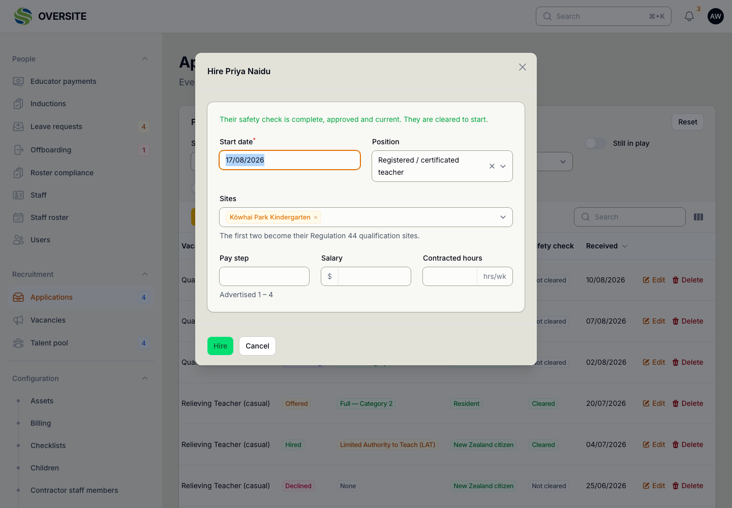 The Hire dialog confirming the candidate's safety check is complete, approved and current, with fields for their start date, position, the centres they will work at, and their pay step against the advertised range.